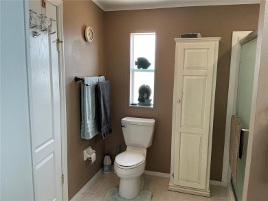 This home truly has it all! Attached RV port built to on Lily Lake Golf and RV Resort in Florida - for sale on GolfHomes.com, golf home, golf lot