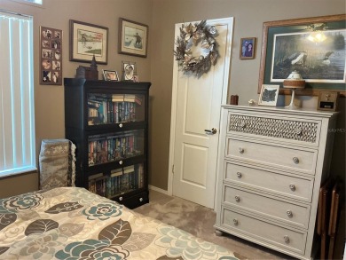 This home truly has it all! Attached RV port built to on Lily Lake Golf and RV Resort in Florida - for sale on GolfHomes.com, golf home, golf lot