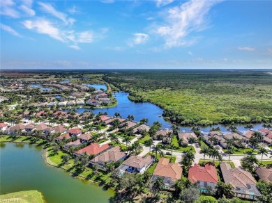 Escape to tranquility overlooking water and panoramic golf on The Golf Club At Fiddlers Creek in Florida - for sale on GolfHomes.com, golf home, golf lot