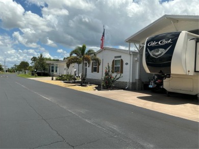 This home truly has it all! Attached RV port built to on Lily Lake Golf and RV Resort in Florida - for sale on GolfHomes.com, golf home, golf lot