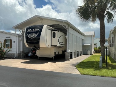 This home truly has it all! Attached RV port built to on Lily Lake Golf and RV Resort in Florida - for sale on GolfHomes.com, golf home, golf lot