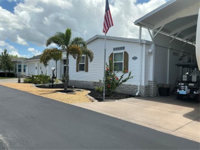 This home truly has it all! Attached RV port built to on Lily Lake Golf and RV Resort in Florida - for sale on GolfHomes.com, golf home, golf lot