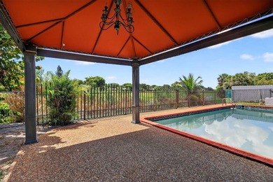 Stunning 4BR/2BA waterfront pool home in prestigious Country on  in Florida - for sale on GolfHomes.com, golf home, golf lot