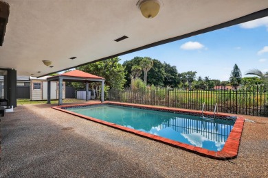 Stunning 4BR/2BA waterfront pool home in prestigious Country on Country Club of Miami in Florida - for sale on GolfHomes.com, golf home, golf lot