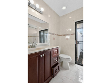 Stunning 4BR/2BA waterfront pool home in prestigious Country on Country Club of Miami in Florida - for sale on GolfHomes.com, golf home, golf lot