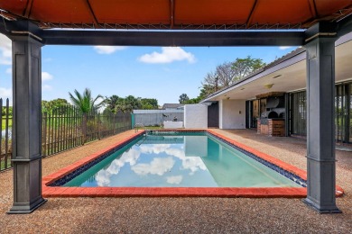 Stunning 4BR/2BA waterfront pool home in prestigious Country on Country Club of Miami in Florida - for sale on GolfHomes.com, golf home, golf lot