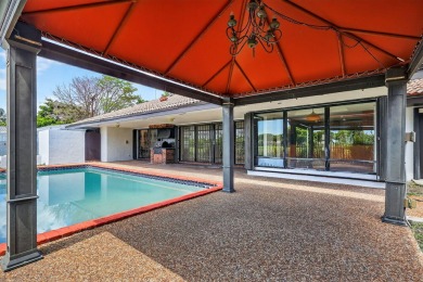 Stunning 4BR/2BA waterfront pool home in prestigious Country on Country Club of Miami in Florida - for sale on GolfHomes.com, golf home, golf lot