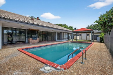 Stunning 4BR/2BA waterfront pool home in prestigious Country on Country Club of Miami in Florida - for sale on GolfHomes.com, golf home, golf lot