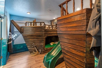 Step into the magical realm of this beautifully themed on The Oasis Club at Champions Gate in Florida - for sale on GolfHomes.com, golf home, golf lot