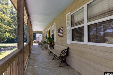 This low country home welcomes you!  The covered front porch on Holly Ridge Golf Course in North Carolina - for sale on GolfHomes.com, golf home, golf lot
