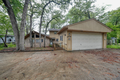 Nestled along the serene waterfront! on Hide-A-Way Lake Golf Course in Texas - for sale on GolfHomes.com, golf home, golf lot