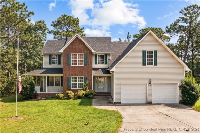 Step onto the covered porch to soak in the peaceful surroundings on Carolina Lakes Country Club in North Carolina - for sale on GolfHomes.com, golf home, golf lot