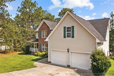 Step onto the covered porch to soak in the peaceful surroundings on Carolina Lakes Country Club in North Carolina - for sale on GolfHomes.com, golf home, golf lot