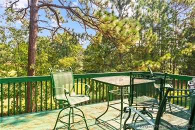 Step onto the covered porch to soak in the peaceful surroundings on Carolina Lakes Country Club in North Carolina - for sale on GolfHomes.com, golf home, golf lot