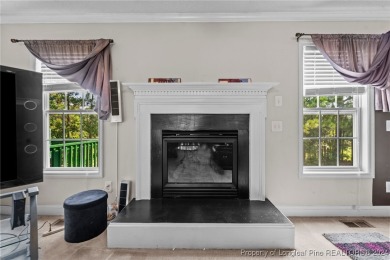 Step onto the covered porch to soak in the peaceful surroundings on Carolina Lakes Country Club in North Carolina - for sale on GolfHomes.com, golf home, golf lot