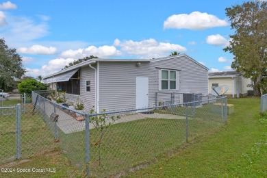 Welcome to this charming 2-bedroom, 2-bathroom manufactured home on Barefoot Bay Golf Course in Florida - for sale on GolfHomes.com, golf home, golf lot