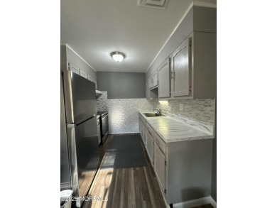 Move right in to this updated 2-bedroom, 1-bath end unit in on Greenbriar Woodlands in New Jersey - for sale on GolfHomes.com, golf home, golf lot