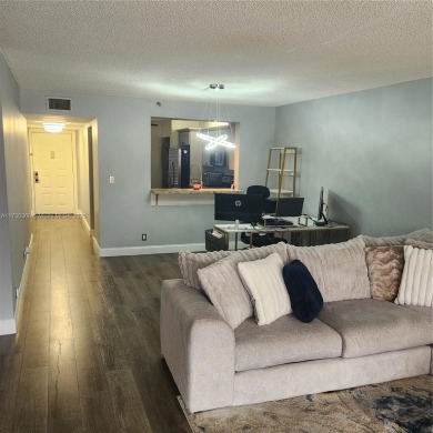 This spacious 2-bedroom condo features laminate wood flooring on Inverrary Country Club in Florida - for sale on GolfHomes.com, golf home, golf lot