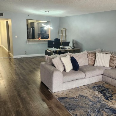 This spacious 2-bedroom condo features laminate wood flooring on Inverrary Country Club in Florida - for sale on GolfHomes.com, golf home, golf lot