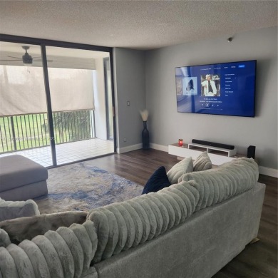 This spacious 2-bedroom condo features laminate wood flooring on Inverrary Country Club in Florida - for sale on GolfHomes.com, golf home, golf lot