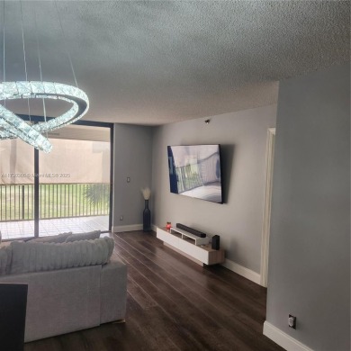 This spacious 2-bedroom condo features laminate wood flooring on Inverrary Country Club in Florida - for sale on GolfHomes.com, golf home, golf lot