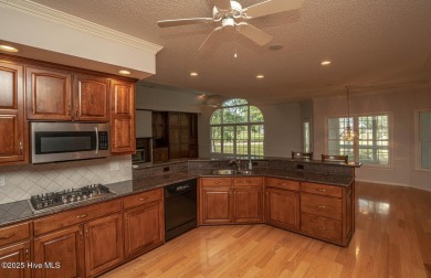 This expansive residence boasts 3 bedrooms, 3.5 bathrooms, and on Oyster Bay Golf Links in North Carolina - for sale on GolfHomes.com, golf home, golf lot