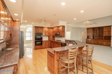 This expansive residence boasts 3 bedrooms, 3.5 bathrooms, and on Oyster Bay Golf Links in North Carolina - for sale on GolfHomes.com, golf home, golf lot