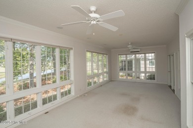 This expansive residence boasts 3 bedrooms, 3.5 bathrooms, and on Oyster Bay Golf Links in North Carolina - for sale on GolfHomes.com, golf home, golf lot