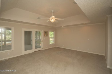 This expansive residence boasts 3 bedrooms, 3.5 bathrooms, and on Oyster Bay Golf Links in North Carolina - for sale on GolfHomes.com, golf home, golf lot