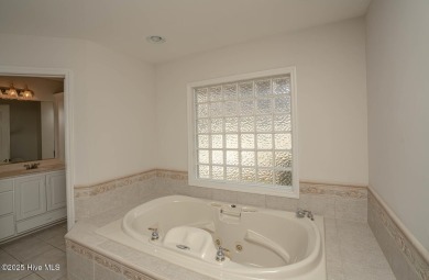 This expansive residence boasts 3 bedrooms, 3.5 bathrooms, and on Oyster Bay Golf Links in North Carolina - for sale on GolfHomes.com, golf home, golf lot