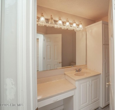 This expansive residence boasts 3 bedrooms, 3.5 bathrooms, and on Oyster Bay Golf Links in North Carolina - for sale on GolfHomes.com, golf home, golf lot