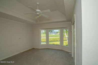 This expansive residence boasts 3 bedrooms, 3.5 bathrooms, and on Oyster Bay Golf Links in North Carolina - for sale on GolfHomes.com, golf home, golf lot