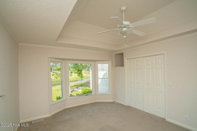 This expansive residence boasts 3 bedrooms, 3.5 bathrooms, and on Oyster Bay Golf Links in North Carolina - for sale on GolfHomes.com, golf home, golf lot