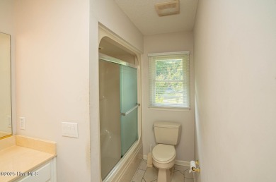 This expansive residence boasts 3 bedrooms, 3.5 bathrooms, and on Oyster Bay Golf Links in North Carolina - for sale on GolfHomes.com, golf home, golf lot