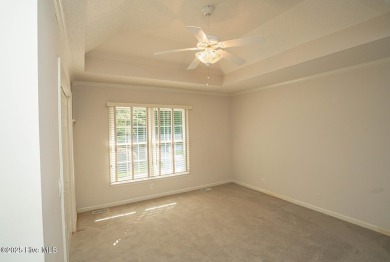 This expansive residence boasts 3 bedrooms, 3.5 bathrooms, and on Oyster Bay Golf Links in North Carolina - for sale on GolfHomes.com, golf home, golf lot