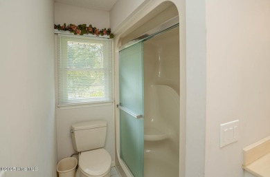 This expansive residence boasts 3 bedrooms, 3.5 bathrooms, and on Oyster Bay Golf Links in North Carolina - for sale on GolfHomes.com, golf home, golf lot