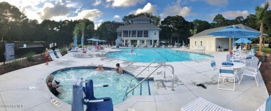 This expansive residence boasts 3 bedrooms, 3.5 bathrooms, and on Oyster Bay Golf Links in North Carolina - for sale on GolfHomes.com, golf home, golf lot