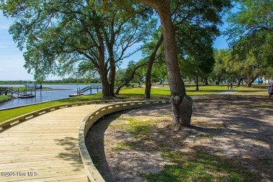 This expansive residence boasts 3 bedrooms, 3.5 bathrooms, and on Oyster Bay Golf Links in North Carolina - for sale on GolfHomes.com, golf home, golf lot