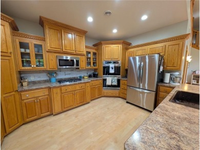 Stunning 4-bedroom, 3-bathroom home offering nearly 5,000 sq ft on Zumbrota Golf Club in Minnesota - for sale on GolfHomes.com, golf home, golf lot