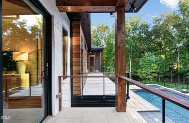 Elegant Modern Style home with views of a forested backyard and on The Preserve At Jordan Lake Golf Club in North Carolina - for sale on GolfHomes.com, golf home, golf lot