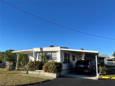 This 2 bedroom 1 1/2 bath home has a screened in porch and on Mangrove Bay Golf Course in Florida - for sale on GolfHomes.com, golf home, golf lot