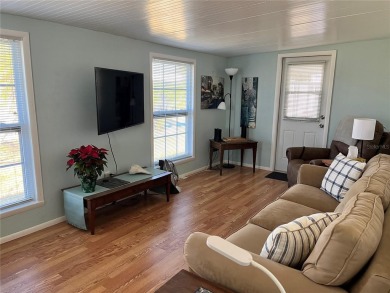 This 2 bedroom 1 1/2 bath home has a screened in porch and on Mangrove Bay Golf Course in Florida - for sale on GolfHomes.com, golf home, golf lot