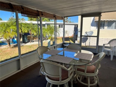 This 2 bedroom 1 1/2 bath home has a screened in porch and on Mangrove Bay Golf Course in Florida - for sale on GolfHomes.com, golf home, golf lot