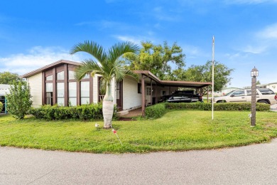 Discover a charming 2-bedroom, 2-bathroom home in the Swiss on Lake Henry Golf Club in Florida - for sale on GolfHomes.com, golf home, golf lot