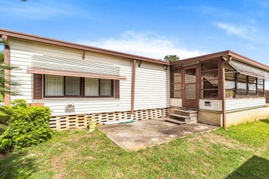 Discover a charming 2-bedroom, 2-bathroom home in the Swiss on Lake Henry Golf Club in Florida - for sale on GolfHomes.com, golf home, golf lot