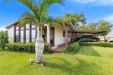 Discover a charming 2-bedroom, 2-bathroom home in the Swiss on Lake Henry Golf Club in Florida - for sale on GolfHomes.com, golf home, golf lot