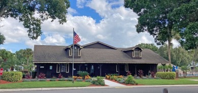 Discover a charming 2-bedroom, 2-bathroom home in the Swiss on Lake Henry Golf Club in Florida - for sale on GolfHomes.com, golf home, golf lot