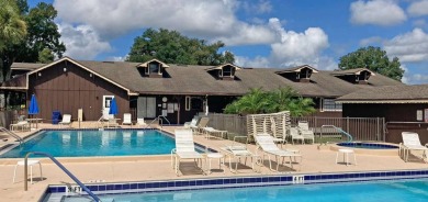 Discover a charming 2-bedroom, 2-bathroom home in the Swiss on Lake Henry Golf Club in Florida - for sale on GolfHomes.com, golf home, golf lot