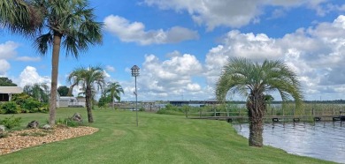 Discover a charming 2-bedroom, 2-bathroom home in the Swiss on Lake Henry Golf Club in Florida - for sale on GolfHomes.com, golf home, golf lot