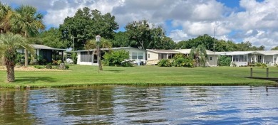 Discover a charming 2-bedroom, 2-bathroom home in the Swiss on Lake Henry Golf Club in Florida - for sale on GolfHomes.com, golf home, golf lot